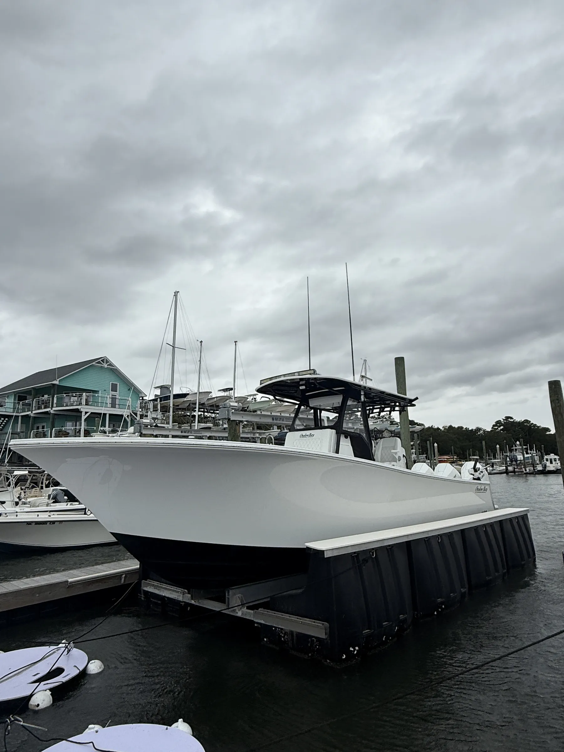 A boat resting on a floating lift at a coastal North Carolina marina